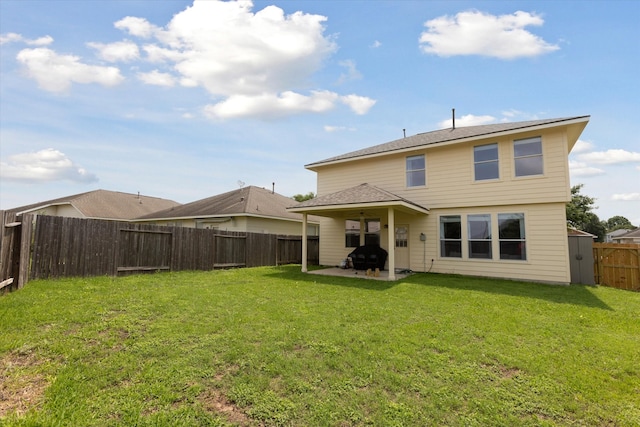 rear view of property featuring a patio area and a lawn