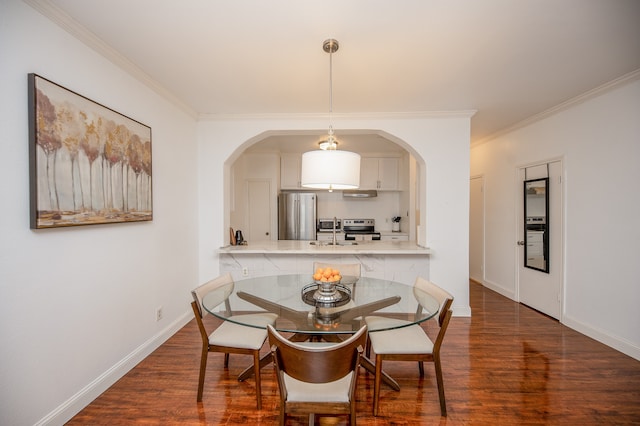 dining space with sink, dark hardwood / wood-style floors, and ornamental molding