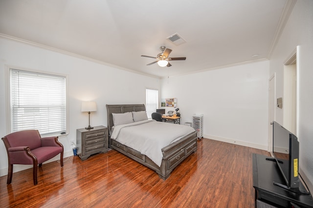 bedroom with ceiling fan, crown molding, and dark wood-type flooring