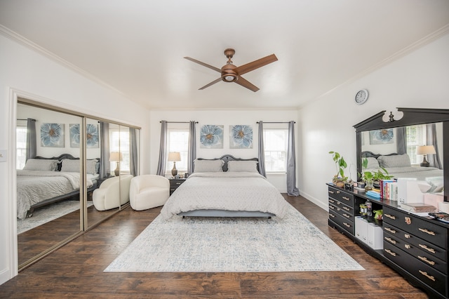 bedroom with dark hardwood / wood-style flooring, ceiling fan, a closet, and crown molding