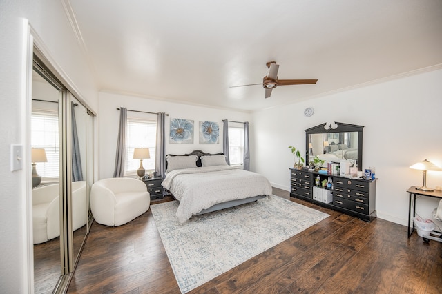 bedroom featuring ceiling fan, a closet, dark hardwood / wood-style floors, and ornamental molding