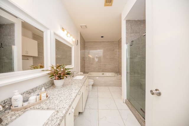 full bathroom featuring separate shower and tub, vanity, and toilet