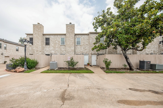 rear view of house featuring central AC unit