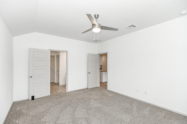 unfurnished bedroom featuring lofted ceiling, ceiling fan, and carpet