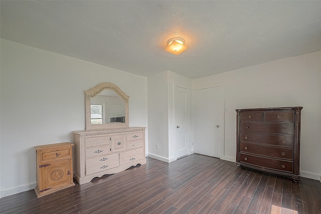 bedroom with dark wood-type flooring