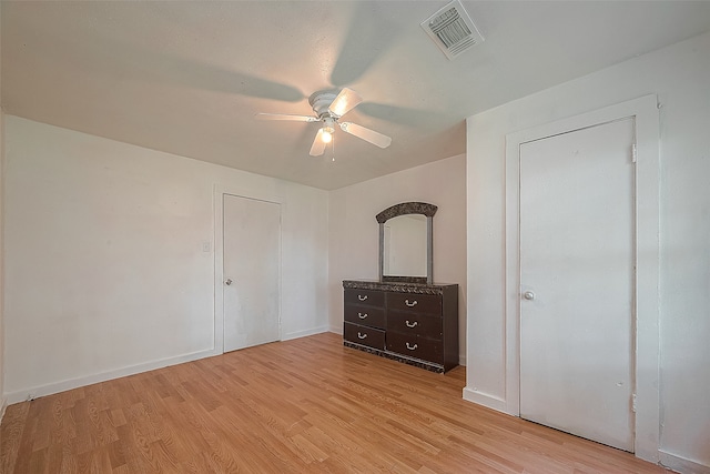 unfurnished bedroom with ceiling fan and light hardwood / wood-style floors