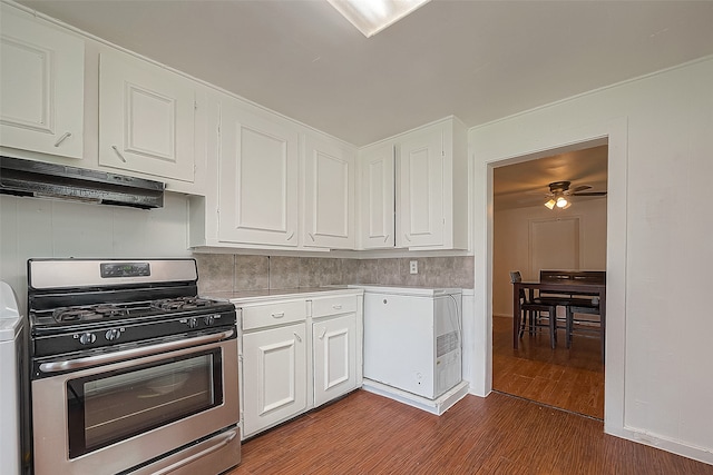 kitchen featuring backsplash, ceiling fan, stainless steel range with gas stovetop, wood-type flooring, and white cabinets