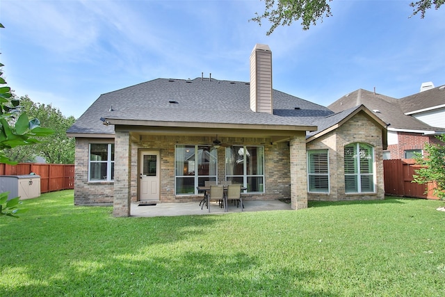 rear view of property featuring a patio, ceiling fan, and a lawn