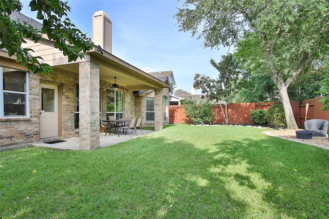 view of yard featuring a patio and ceiling fan