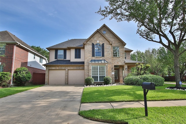 view of front of home with a garage and a front lawn