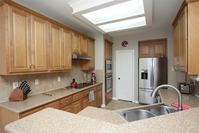 kitchen featuring sink, appliances with stainless steel finishes, and backsplash