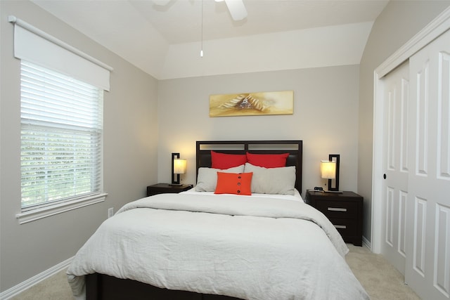 carpeted bedroom featuring a closet, ceiling fan, and vaulted ceiling