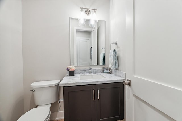 bathroom with toilet and vanity