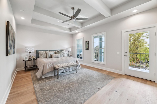 bedroom featuring baseboards, multiple windows, light wood-style flooring, and access to exterior