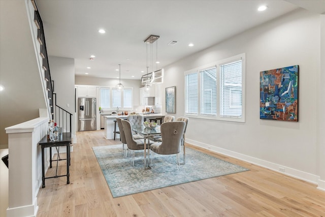 dining area featuring light wood-type flooring, visible vents, baseboards, and recessed lighting