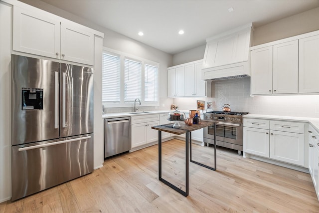 kitchen with white cabinetry, stainless steel appliances, and light countertops