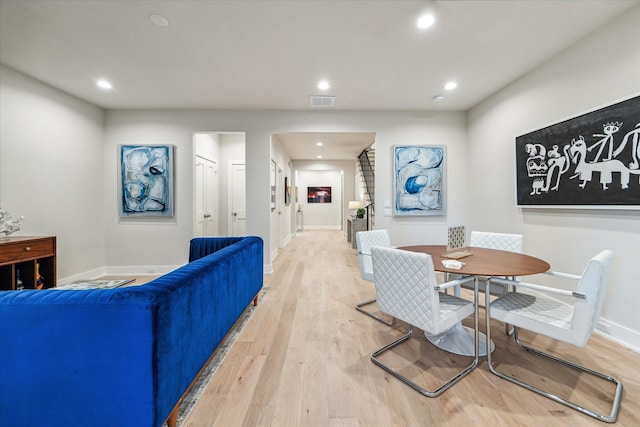 dining room featuring recessed lighting, a fireplace, visible vents, baseboards, and light wood-style floors