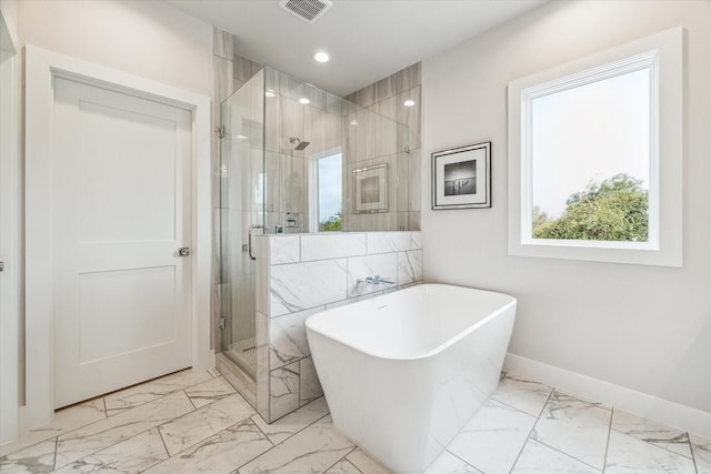 full bath featuring marble finish floor, baseboards, visible vents, and a soaking tub