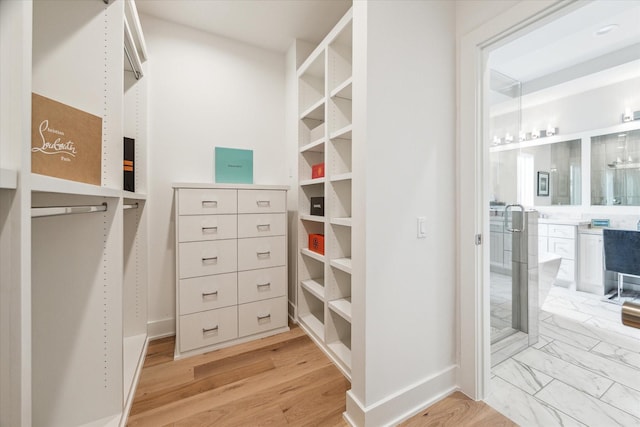 walk in closet with marble finish floor