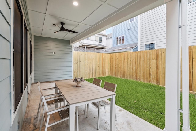 view of patio / terrace featuring a ceiling fan, outdoor dining space, and a fenced backyard