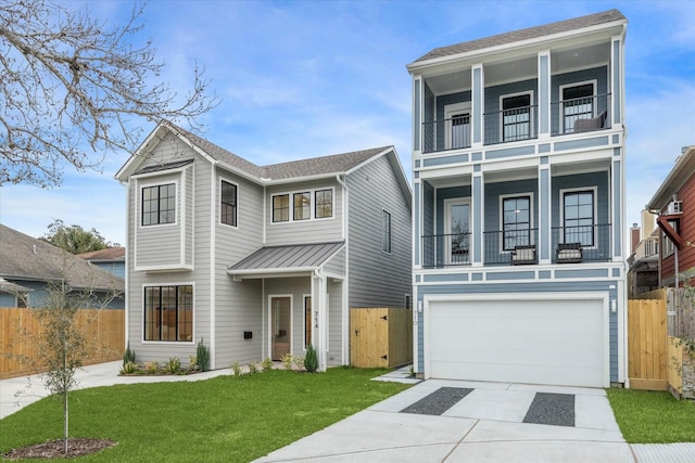 view of front of house with driveway, a balcony, an attached garage, fence, and a front yard