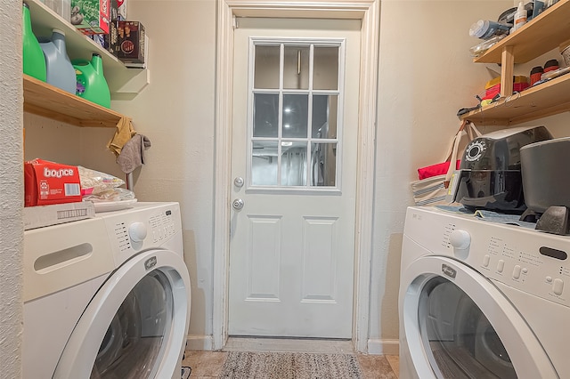 clothes washing area featuring light tile floors