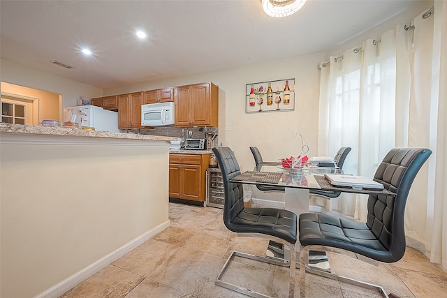 tiled dining space featuring beverage cooler