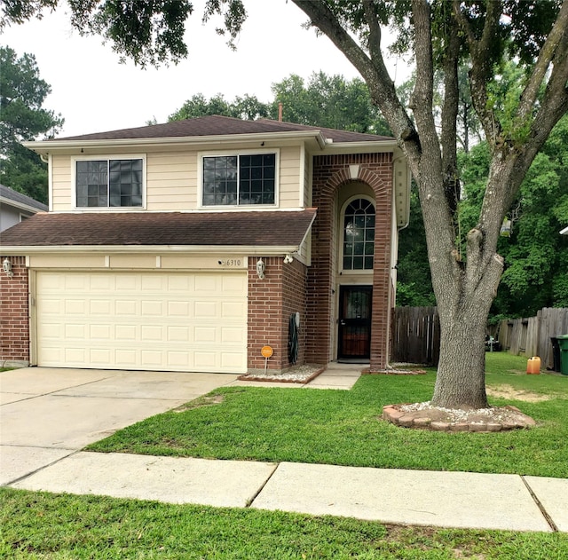 view of front of house featuring a garage and a front yard