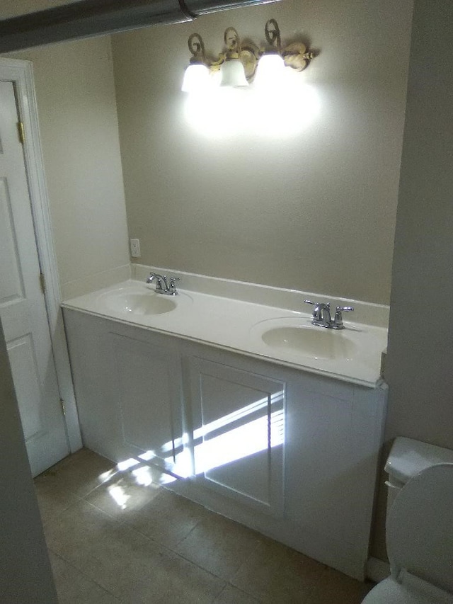 bathroom featuring tile patterned flooring, vanity, and toilet