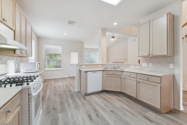 kitchen featuring ceiling fan, white appliances, backsplash, light hardwood / wood-style flooring, and kitchen peninsula