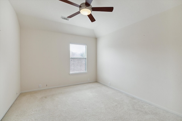 carpeted empty room with ceiling fan and lofted ceiling