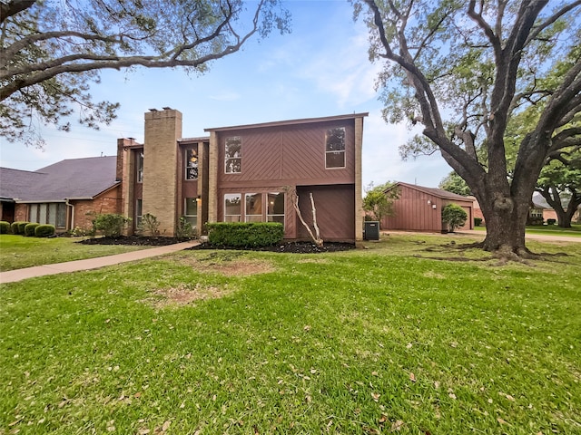 rear view of house featuring a lawn