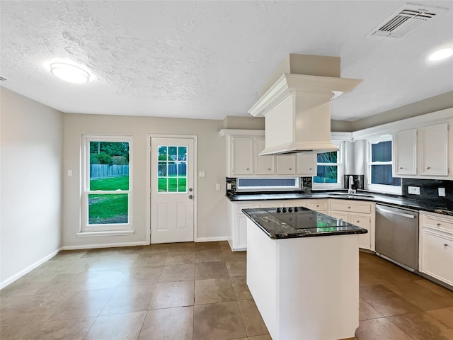 kitchen with a center island, tile floors, custom range hood, sink, and stainless steel dishwasher