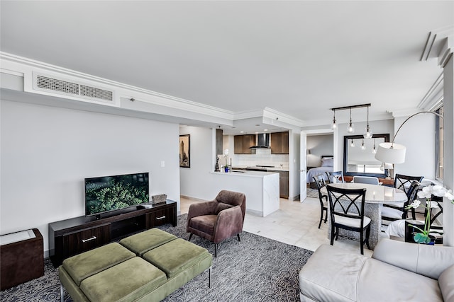 living room with light tile flooring and crown molding