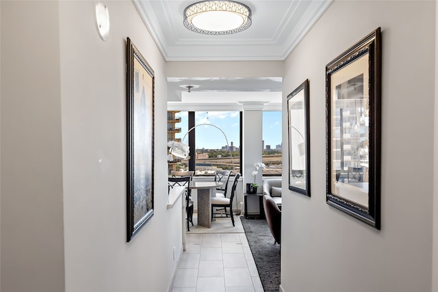 hallway with crown molding and light tile floors