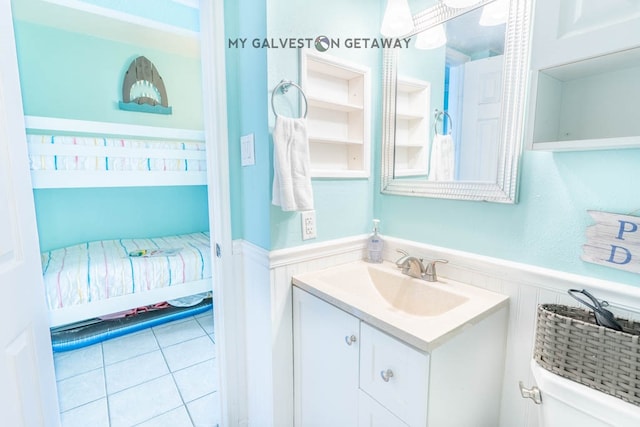 bathroom featuring tile floors, toilet, and oversized vanity