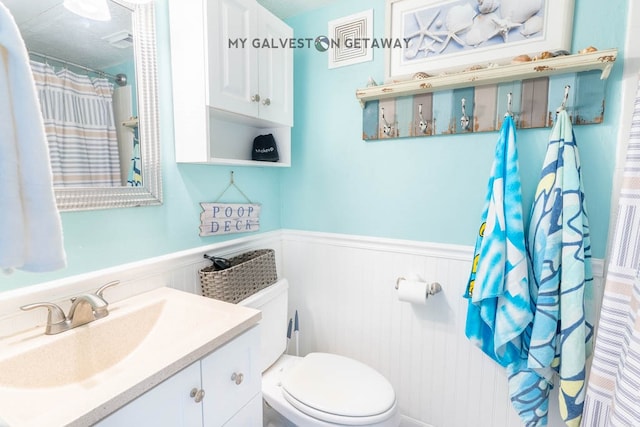 bathroom featuring toilet and vanity