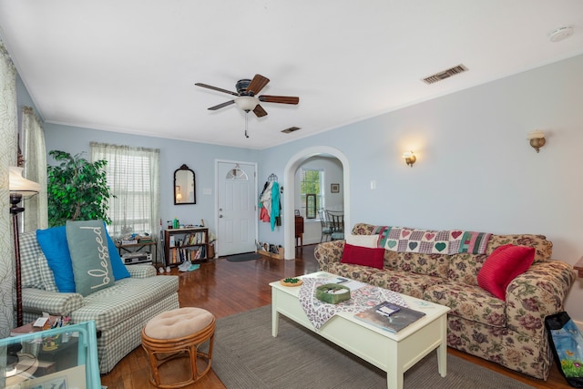 living room featuring ceiling fan and dark hardwood / wood-style flooring