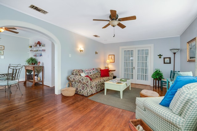 living room featuring hardwood / wood-style floors, ceiling fan, crown molding, and french doors