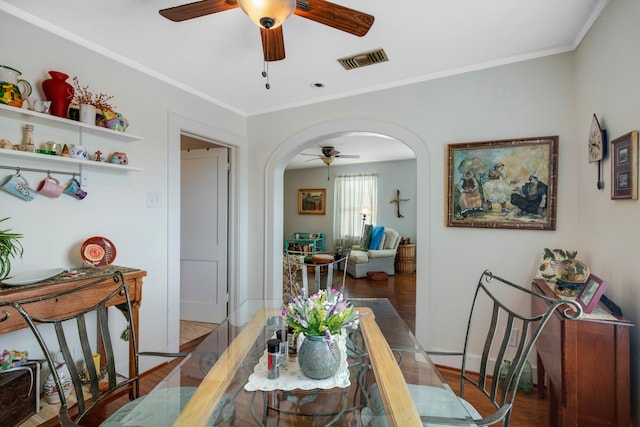 dining room featuring wood-type flooring, ceiling fan, and crown molding