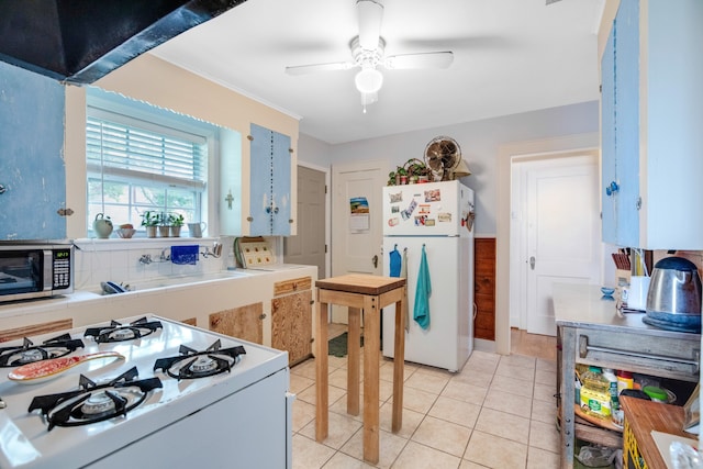 kitchen featuring white fridge, backsplash, ceiling fan, stove, and light tile floors