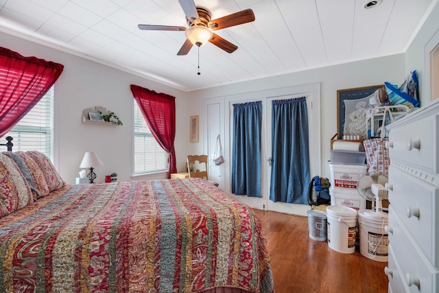 bedroom featuring ceiling fan, hardwood / wood-style flooring, and ornamental molding