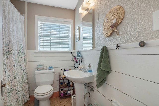 bathroom featuring tile floors and toilet