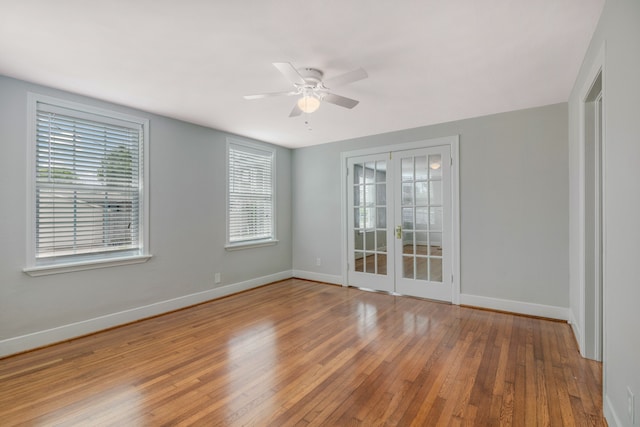 unfurnished room with hardwood / wood-style floors, ceiling fan, and french doors