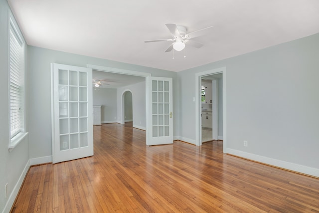 spare room with ceiling fan, hardwood / wood-style flooring, and plenty of natural light