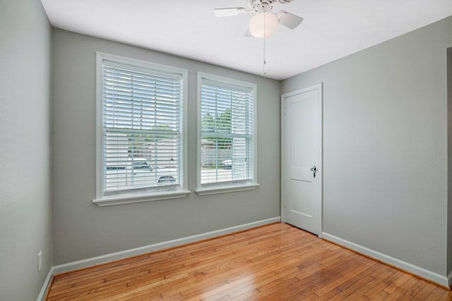 unfurnished room featuring light hardwood / wood-style floors, ceiling fan, and a wealth of natural light