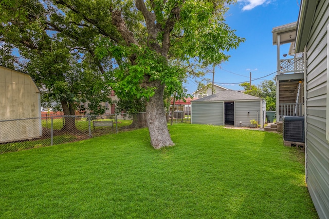 view of yard with an outdoor structure and central AC