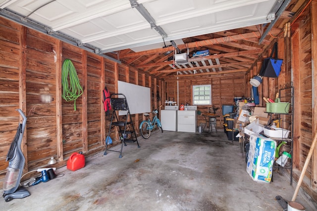 garage with washing machine and dryer and a garage door opener