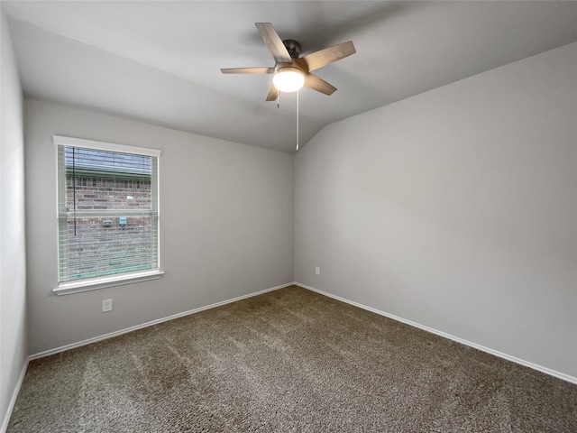 carpeted empty room with vaulted ceiling and ceiling fan