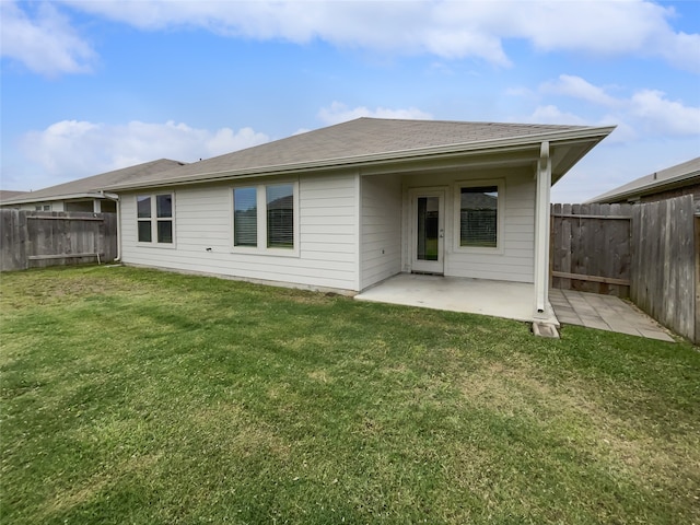 rear view of house with a lawn and a patio area